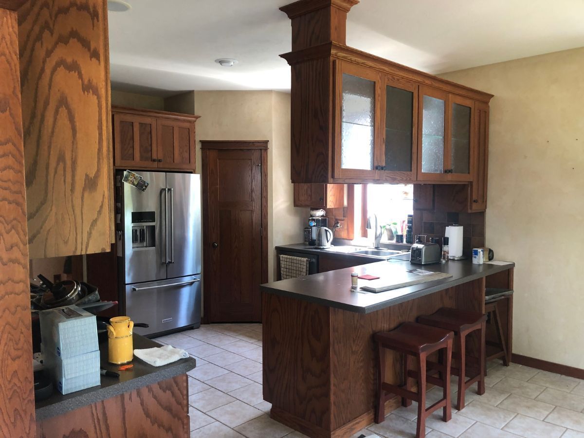 A kitchen with stainless steel appliances and wooden cabinets