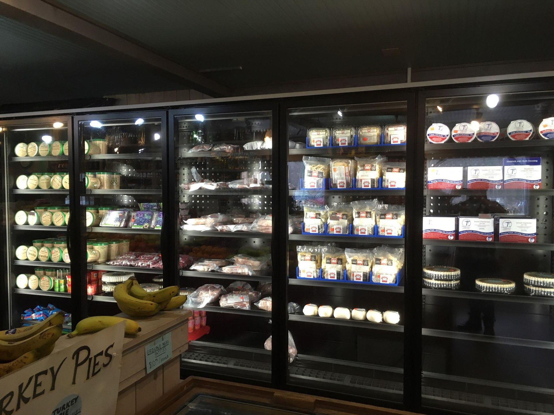 The inside of a grocery store with a sign that says turkey pies