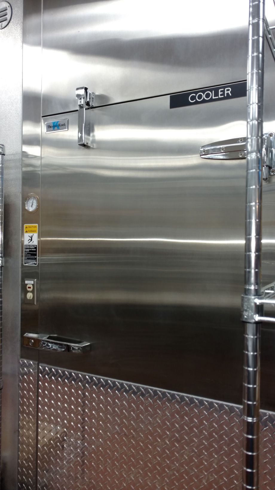 A stainless steel refrigerator with the word cooler on it