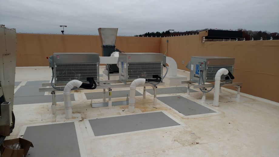 A rooftop with a lot of pipes coming out of it