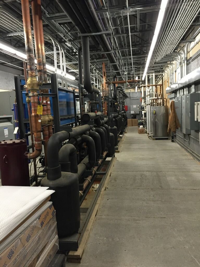 A long hallway filled with lots of pipes and tubes