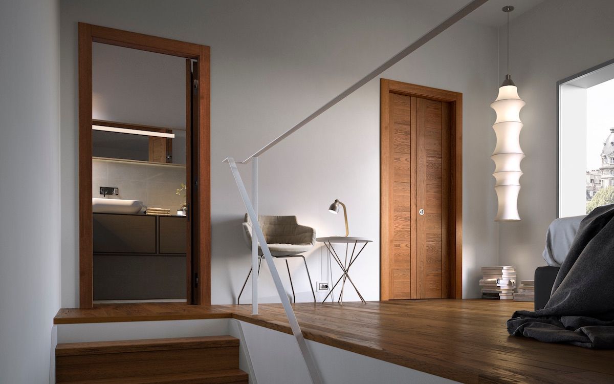 Camera da letto moderna con pavimento in legno, porta a specchio, scrivania, sedia e lampada a sospensione bianca vicino a una finestra.