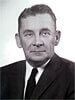 Man in a suit and tie, looking directly at the camera.