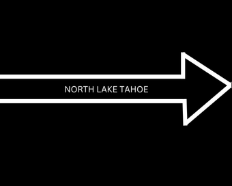 White arrow sign on black background labeled “North Lake Tahoe,” pointing right.