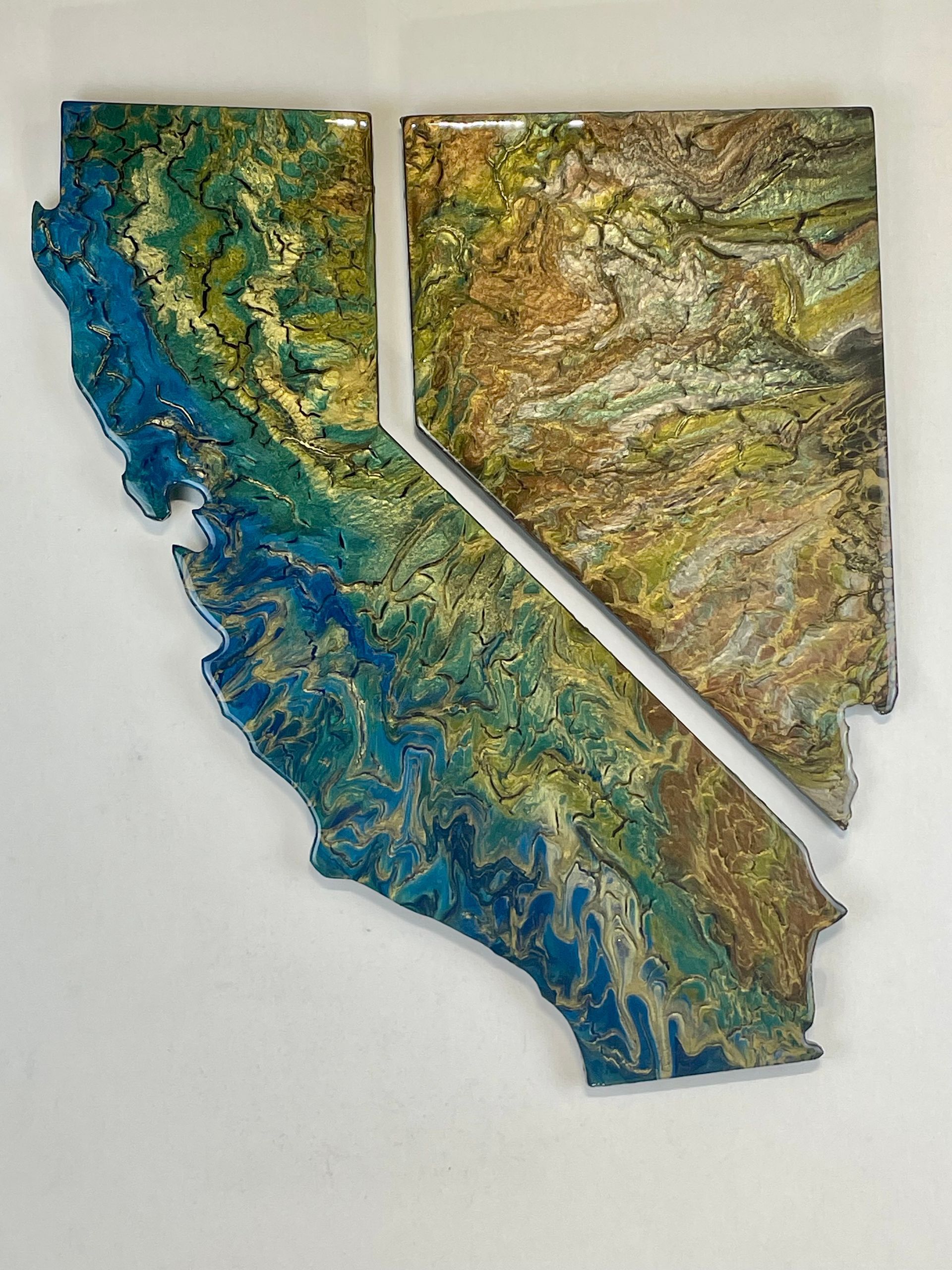 Topographic map of California in blue, green, and tan on a white background