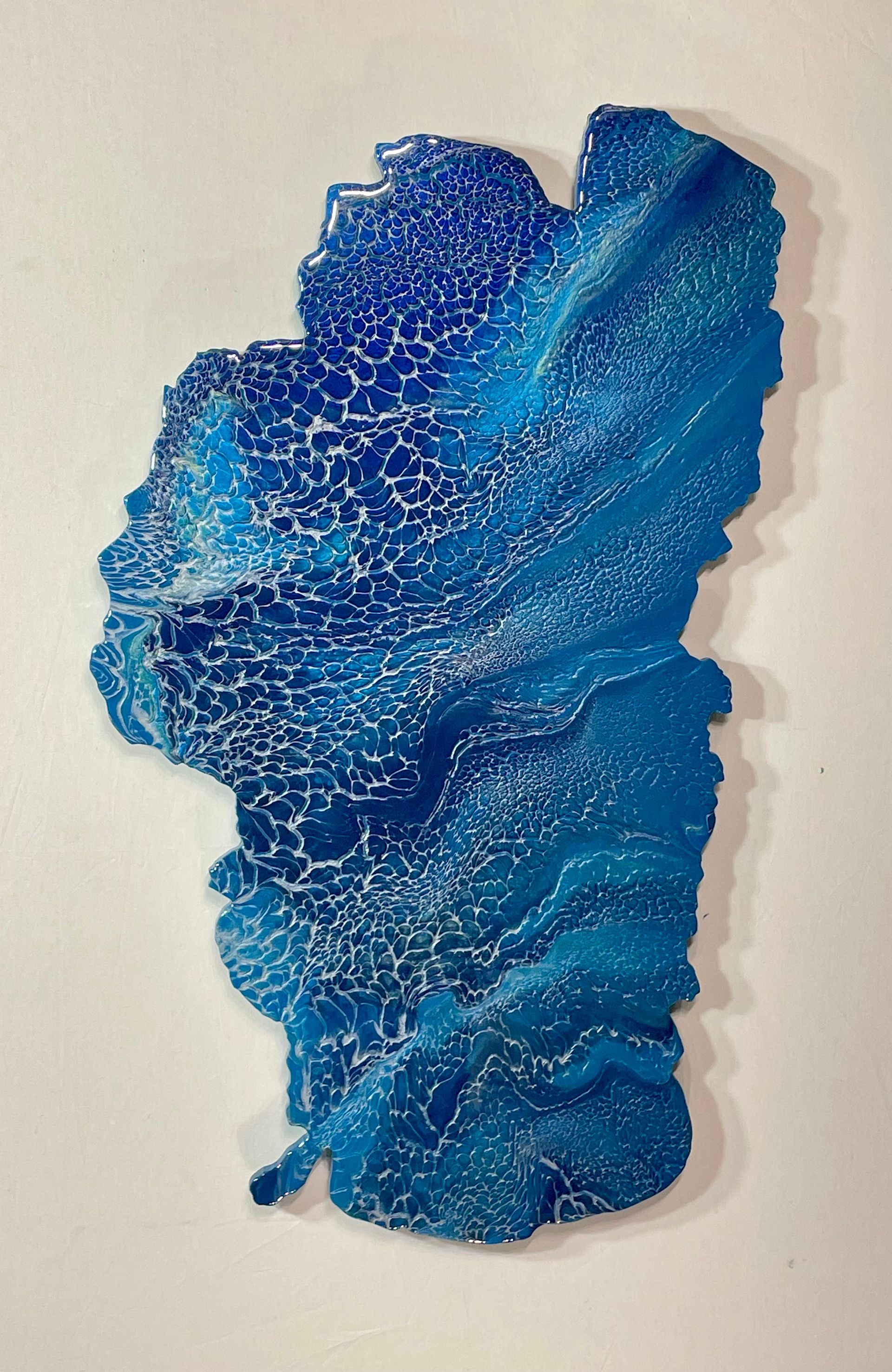 Blue abstract textured art piece with layered swirls and glitter-like speckles on a light background