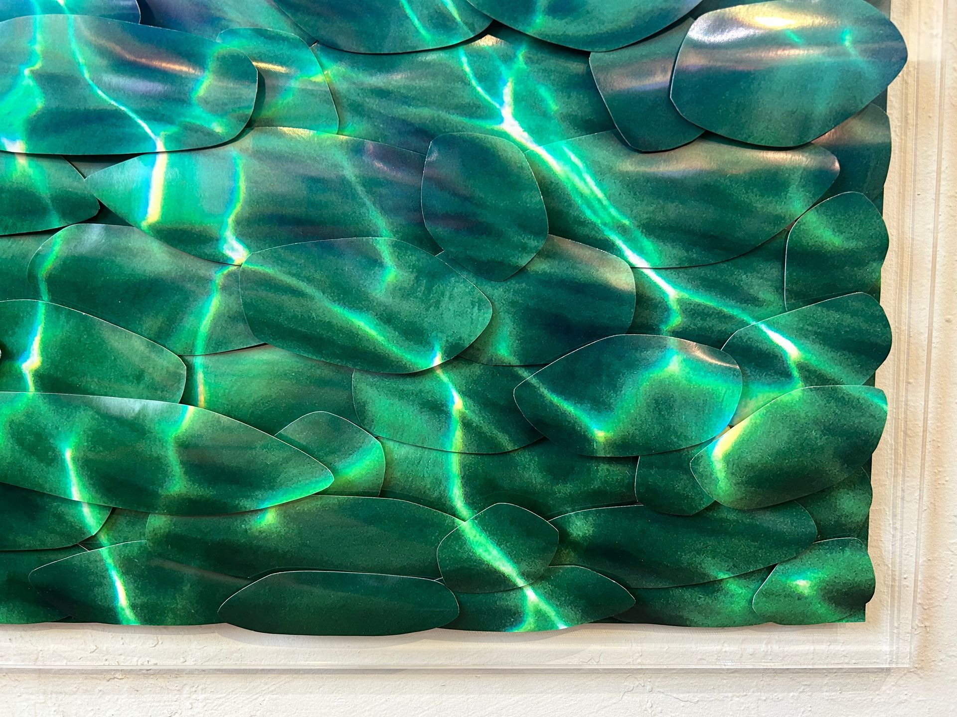 Abstract green glass-like mosaic with rippling light reflections