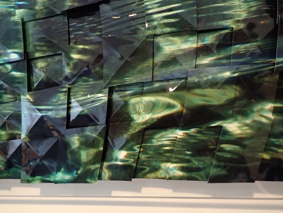 Abstract green and blue geometric wall art with layered, reflective panels