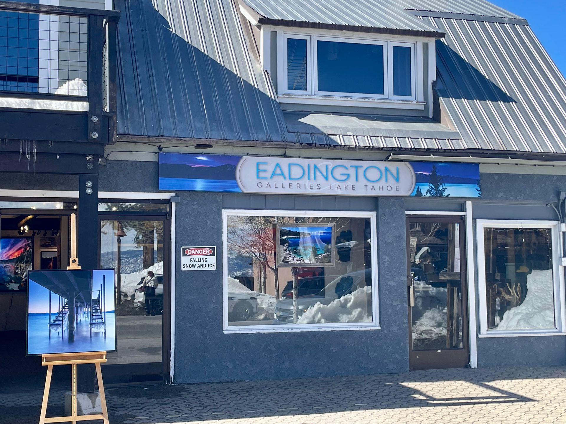 Storefront with a blue “EADINGTON” sign, large windows, and a display easel outside