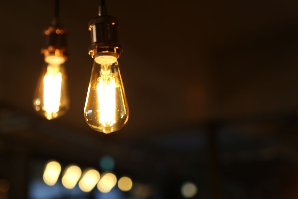 Glowing Hanging Light Bulbs Against a Dark — CQ Pro-Lec in Pacific Heights, QLD