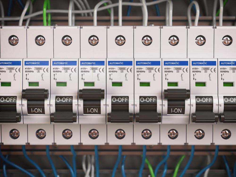 Row of Electrical Circuit Breakers With Blue Labels and Black Switches — CQ Pro-Lec in Pacific Heights, QLD