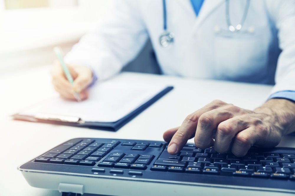 Doctor Checking Results on Computer — Endoscopist & General Surgeon in Mackay, QLD