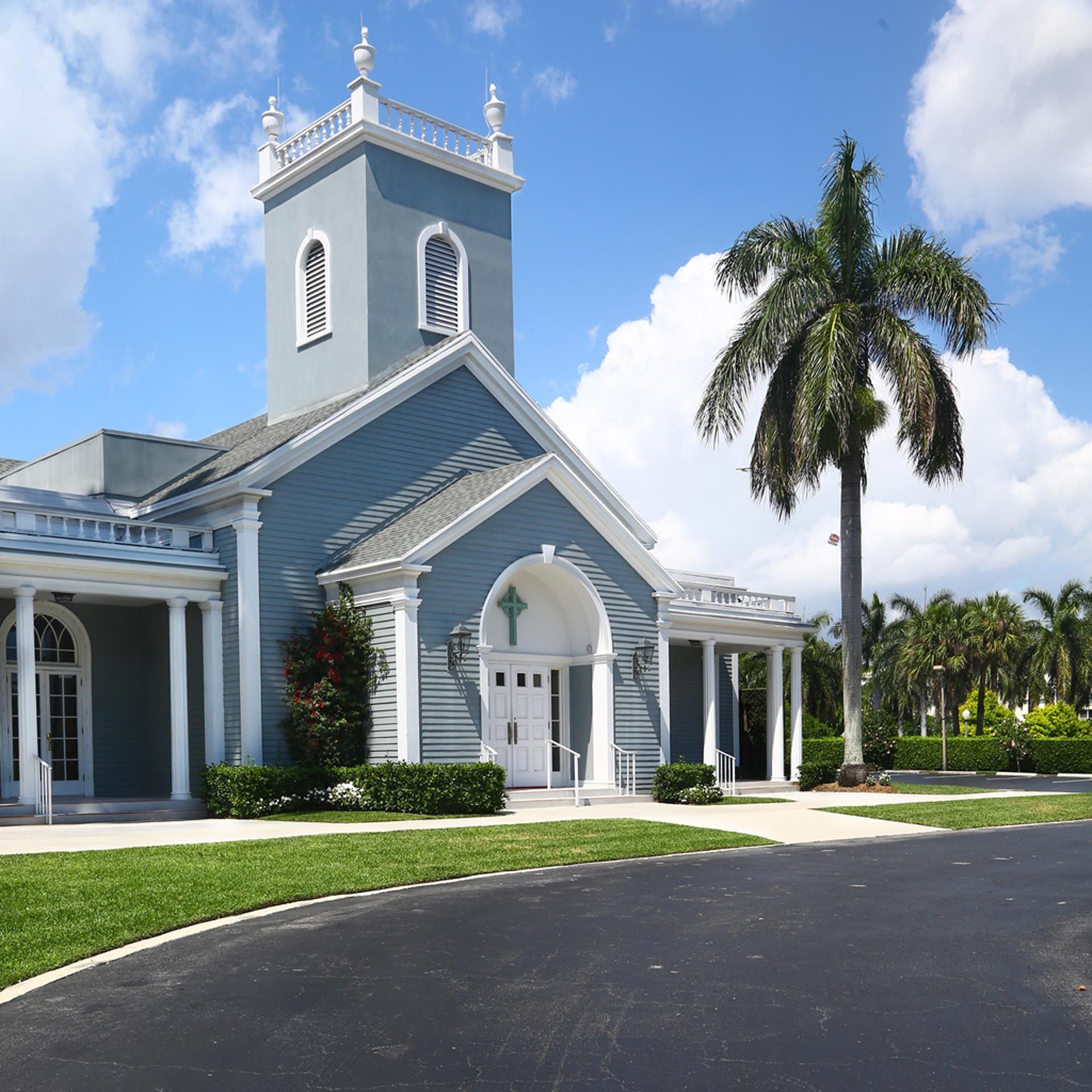 A church with a palm tree in front of it