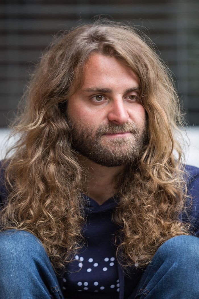 A close-up of founder Dan Mancina's face and long, curly hair.