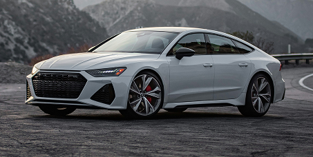 Silver Audi sedan parked on a mountain road with misty hills in the background | Kars Performance