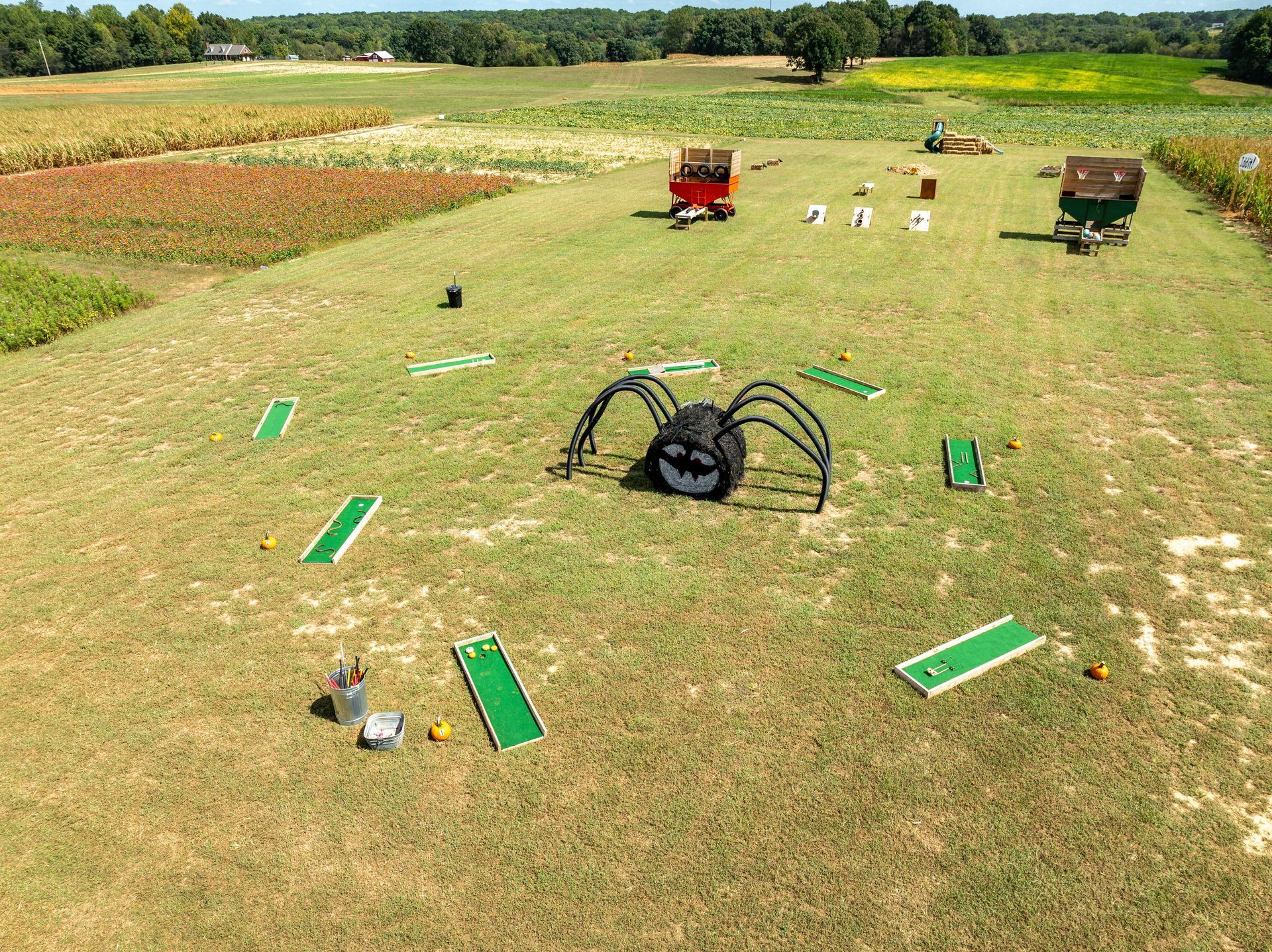 An aerial view of a maze made out of hay bales in a grassy field.