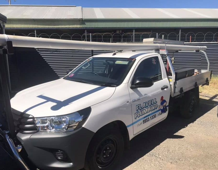 A White Truck Is Parked In Front Of A Building — Flavell Plumbing (NT) Pty Ltd In Ciccone, NT
