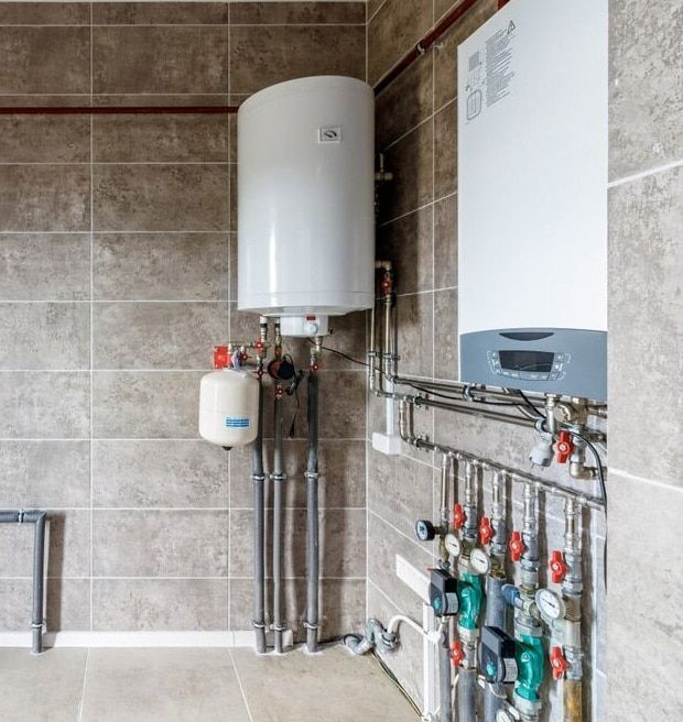 A Room With A Water Heater And A Boiler On The Wall — Flavell Plumbing (NT) Pty Ltd In Ciccone, NT