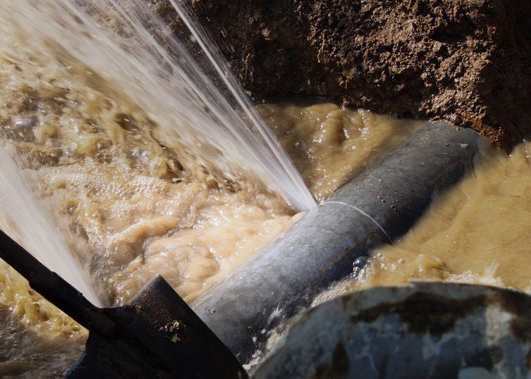 A Pipe Is Leaking Water Into A Bucket — Flavell Plumbing (NT) Pty Ltd In Ciccone, NT