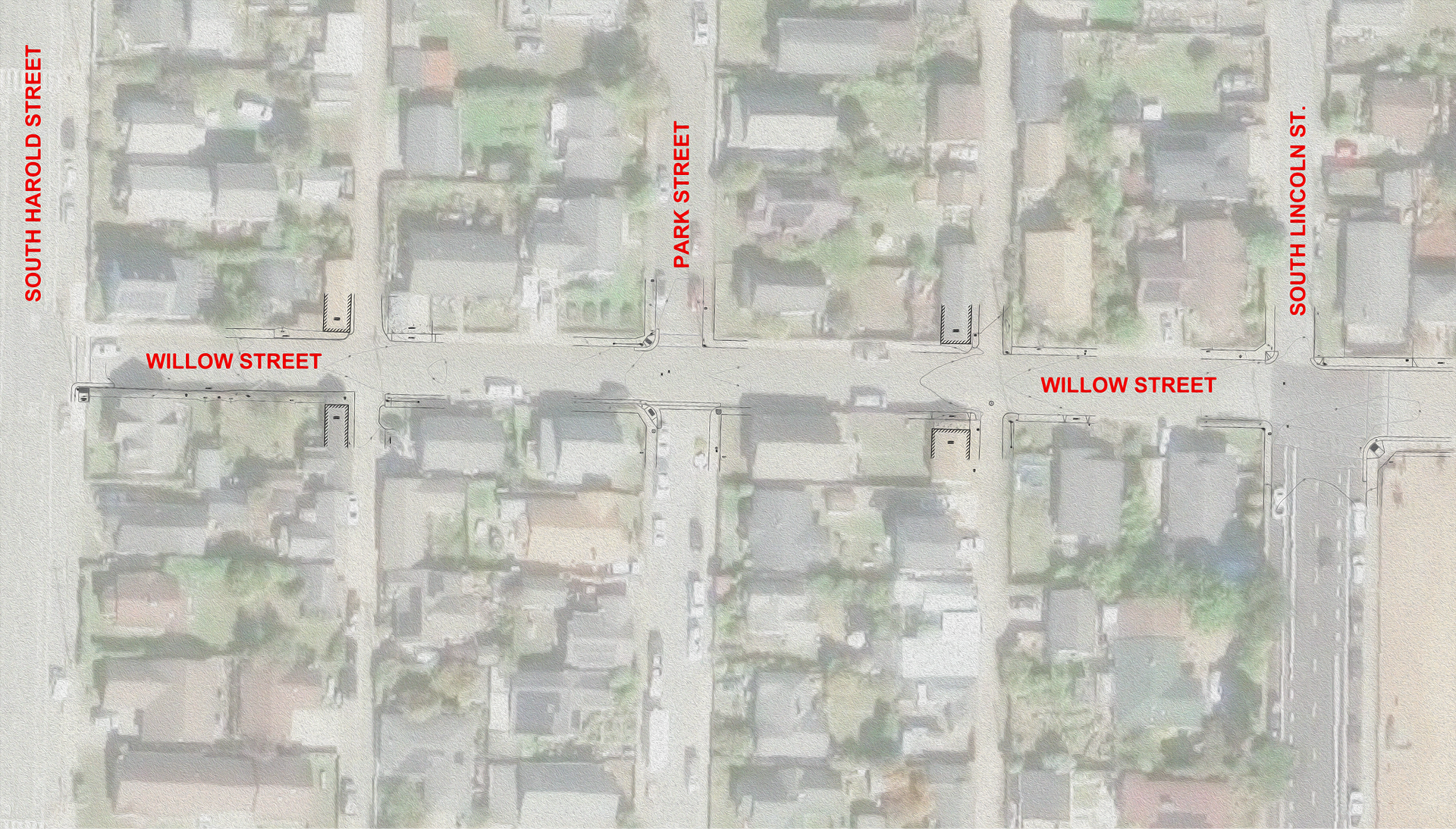 Aerial view of a neighborhood map with red street labels and intersecting roads.