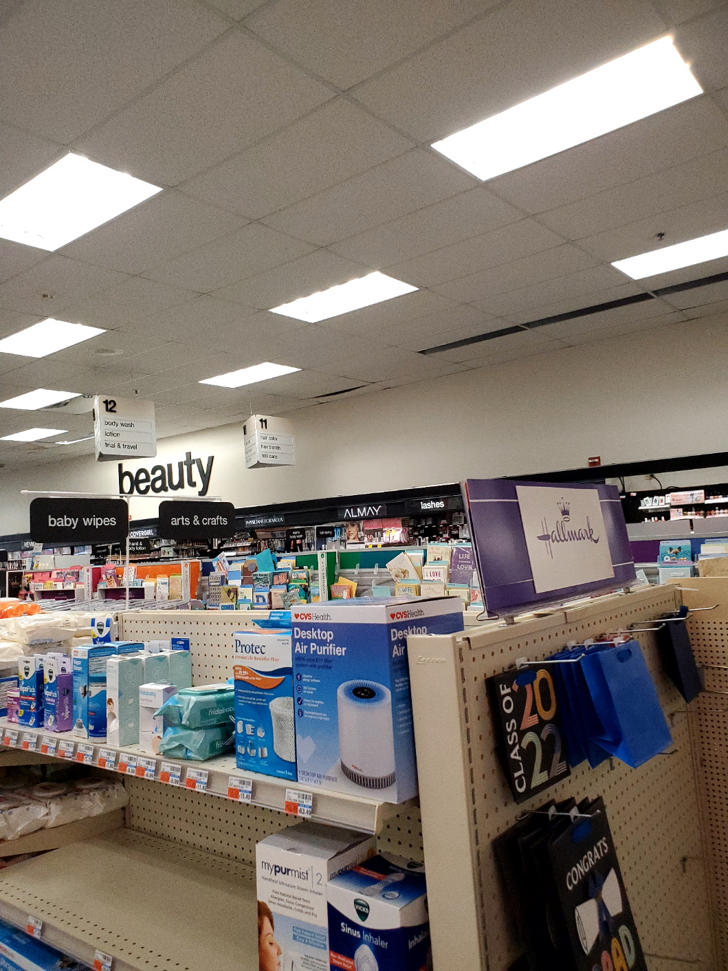 A store aisle with a sign that says beauty on it