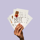 Hand holding fanned cards with a woman illustration and the word “BEST” on a light purple background