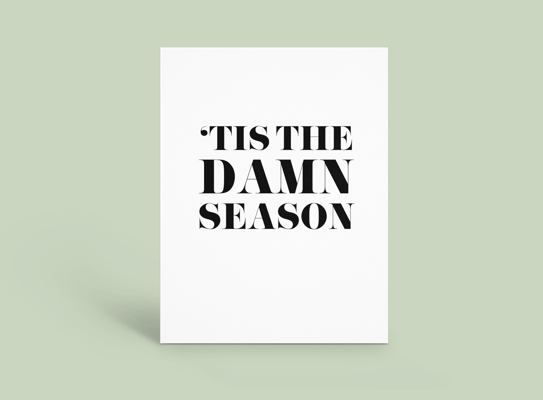 White poster with bold black text reading “’TIS THE DAMN SEASON” on a pale green background.