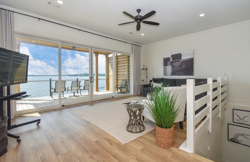 Bright modern living room with sliding glass doors opening to a balcony and ocean view