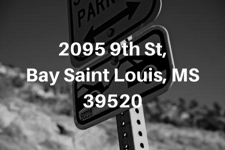 Street sign in the background of text reading “2095 9th St, Bay Saint Louis, MS 39520” against a remaining blurred outdoor background