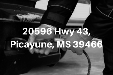 Background picture of hands hooking up a tow cable and white text in forefront that reads  