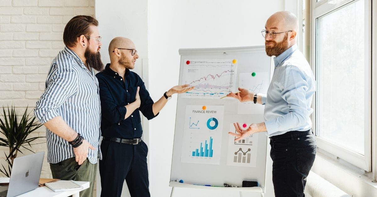 Business advisors reviewing financial growth charts and performance data, representing strategic bus