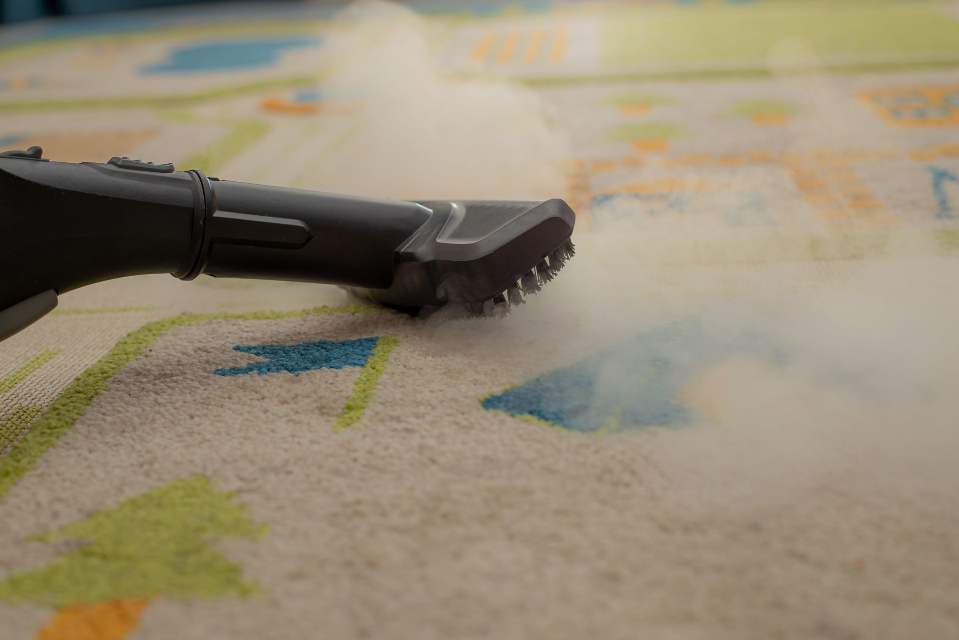 Vacuum cleaner on a patterned rug beside a white curtain