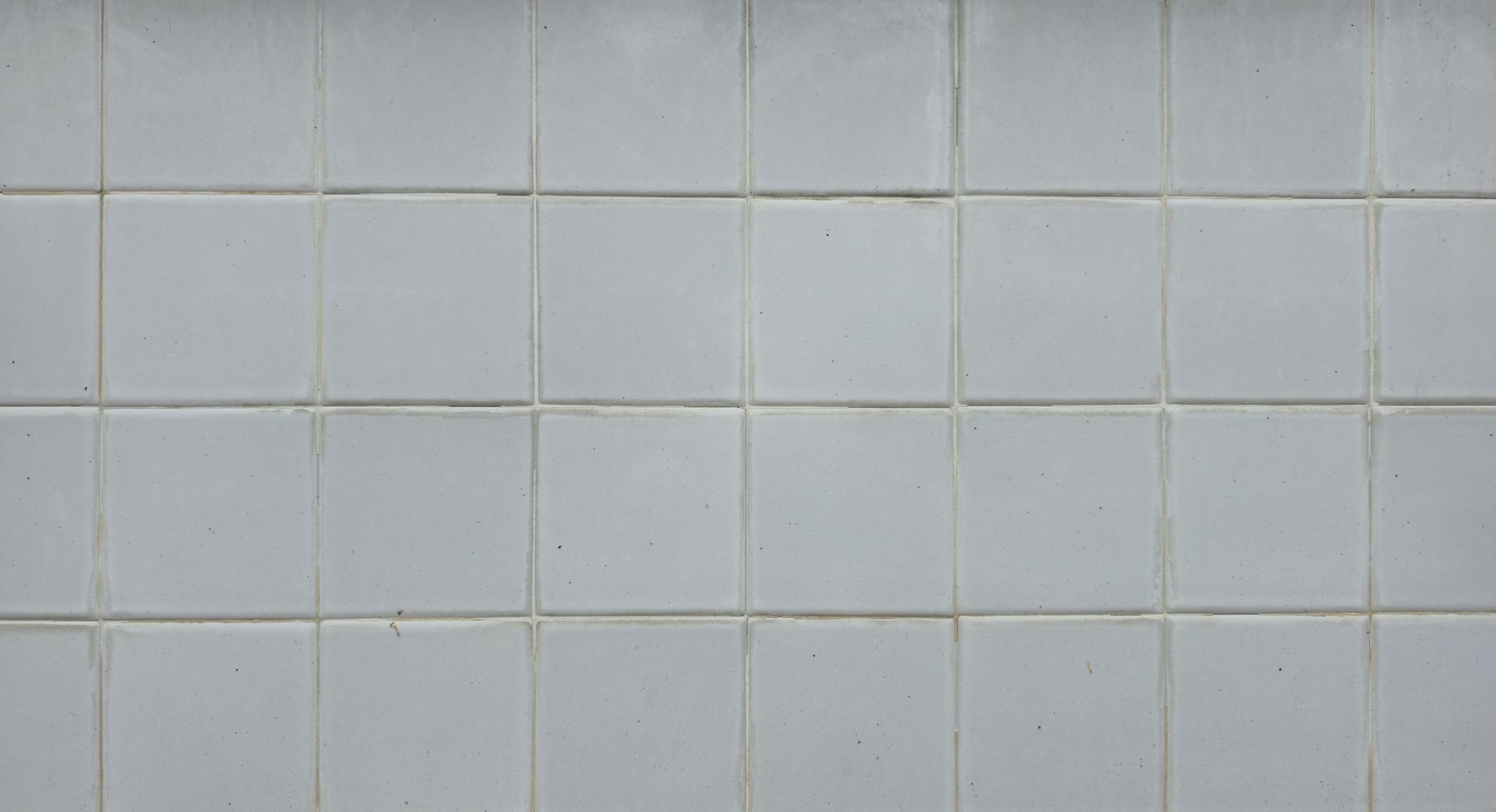 White robot vacuum on a tiled floor