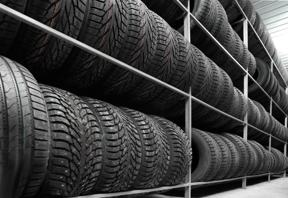 A Warehouse Filled With Lots Of Tires Stacked On Top Of Each Other — Camden Haven Tyre & Service Centre In Laurieton, NSW