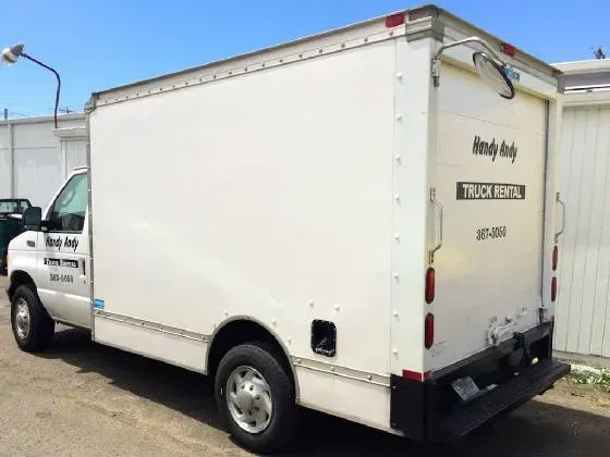 White box truck parked outdoors, labeled