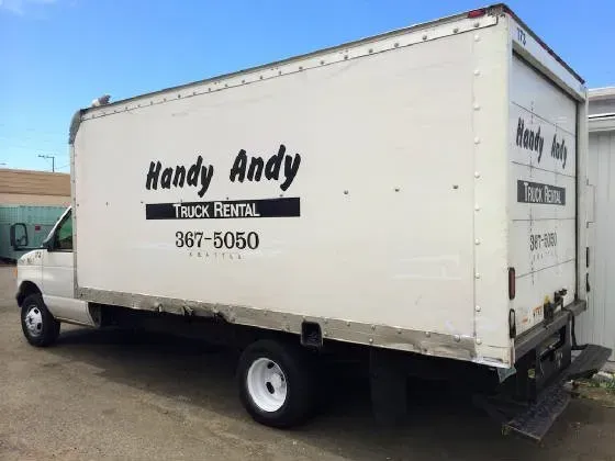 White Handy Andy truck rental vehicle parked outdoors.
