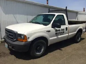 White Ford pickup truck parked outside a building, with
