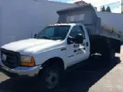 White dump truck parked on a sunny day.