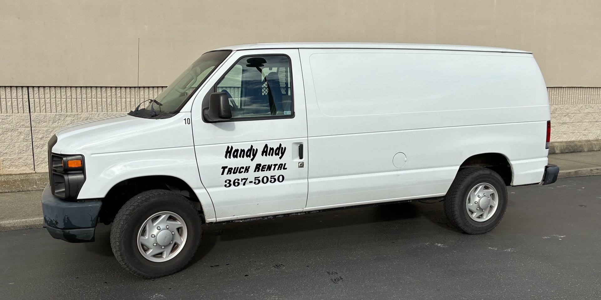 White cargo van with company lettering parked on a street