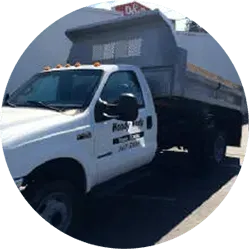 White dump truck parked on a sunny day.