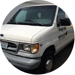 White Ford van with company logo parked outside.