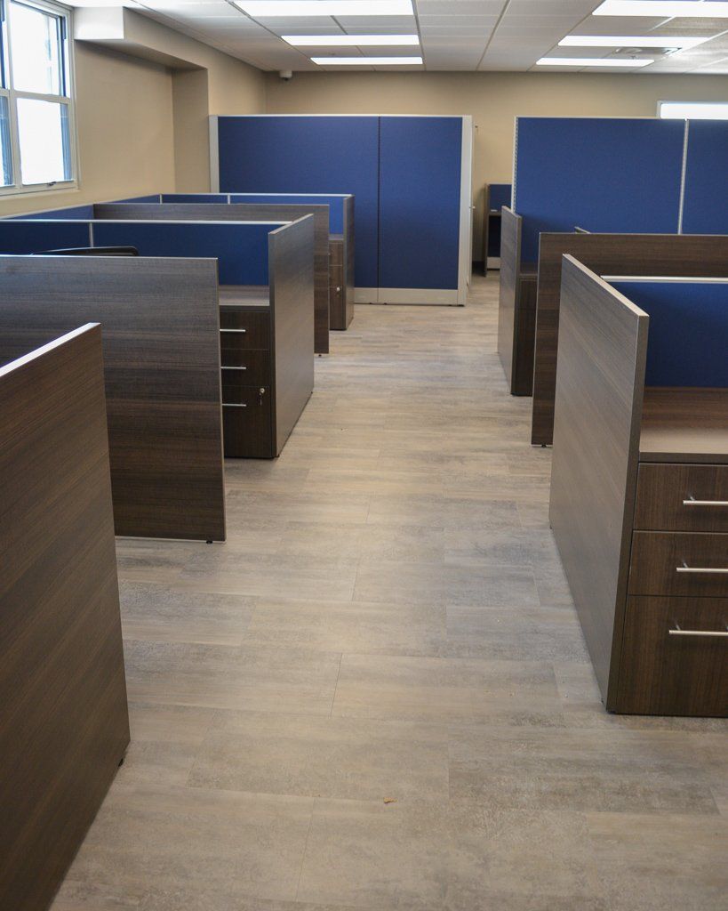 a row of cubicles in an office with blue dividers