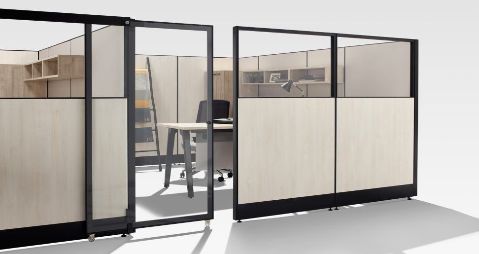 a cubicle with a desk and chair in it