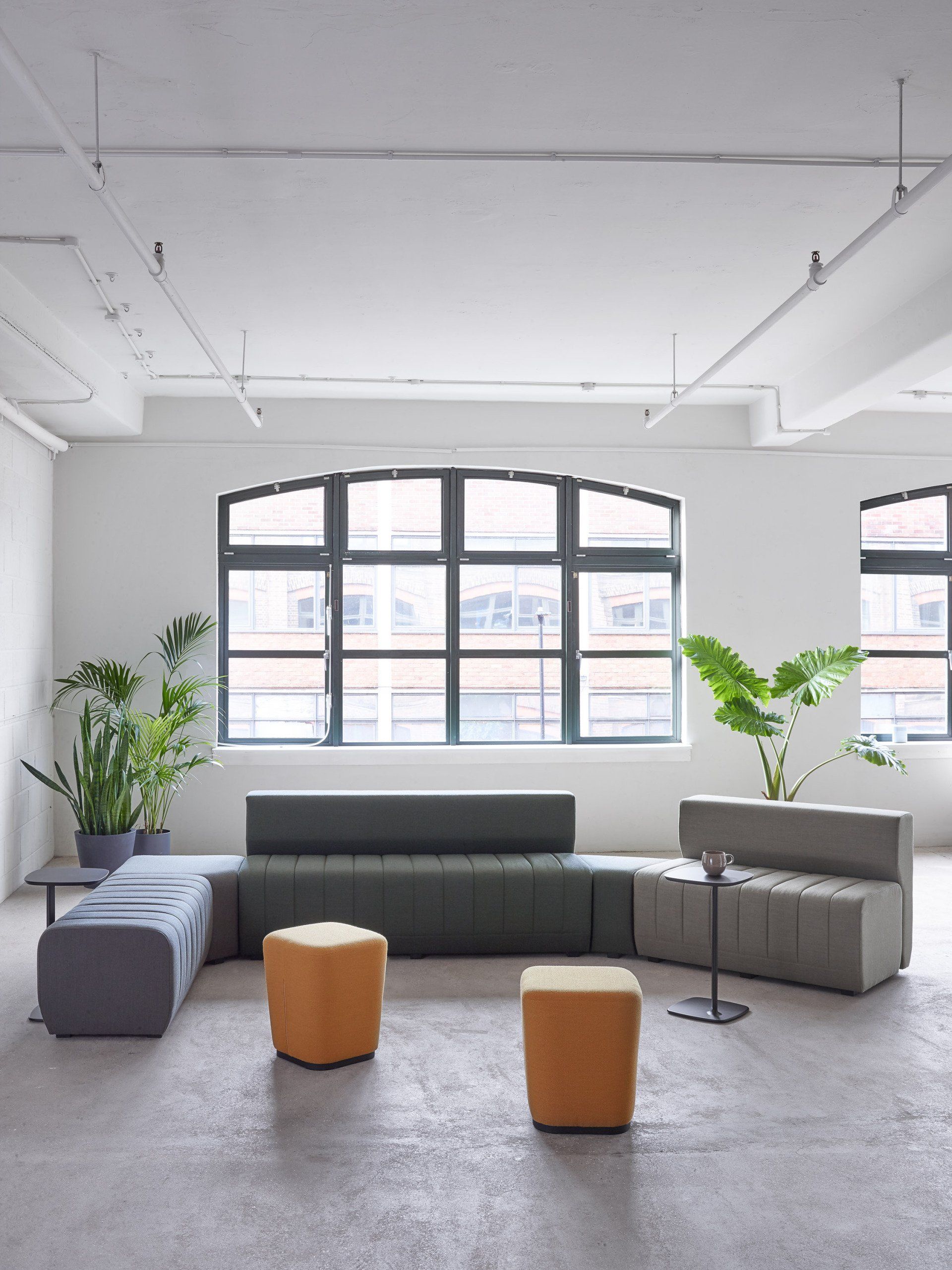 Collaborative seating with modular sofa, ottomans