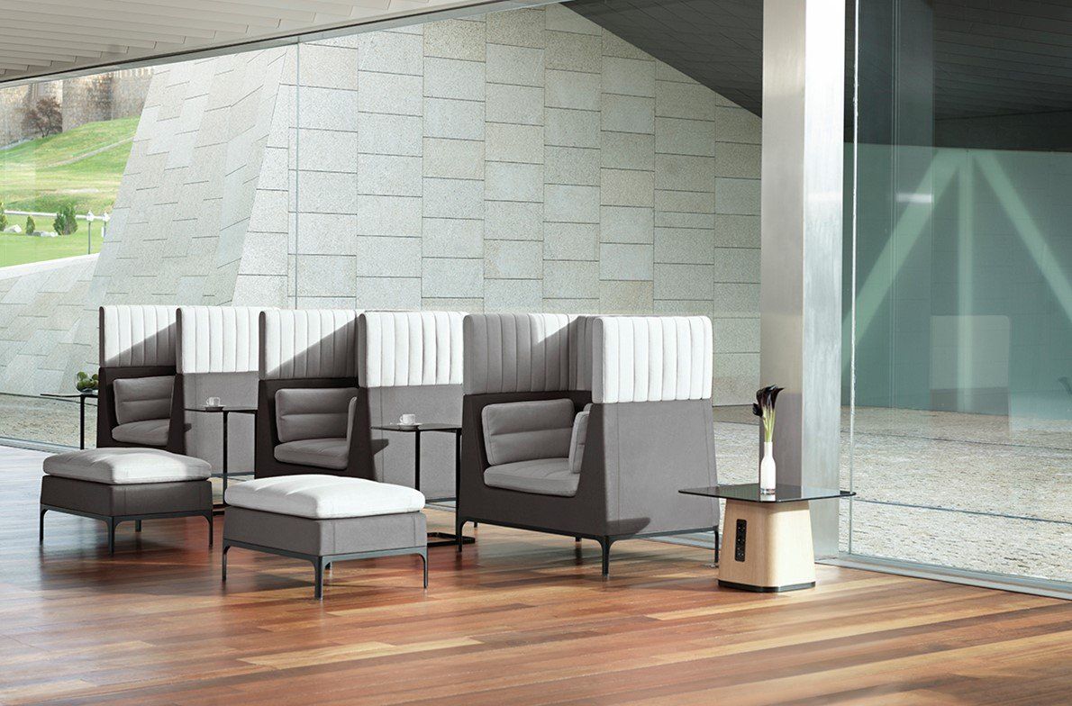 Row of gray privacy armchairs with ottomans