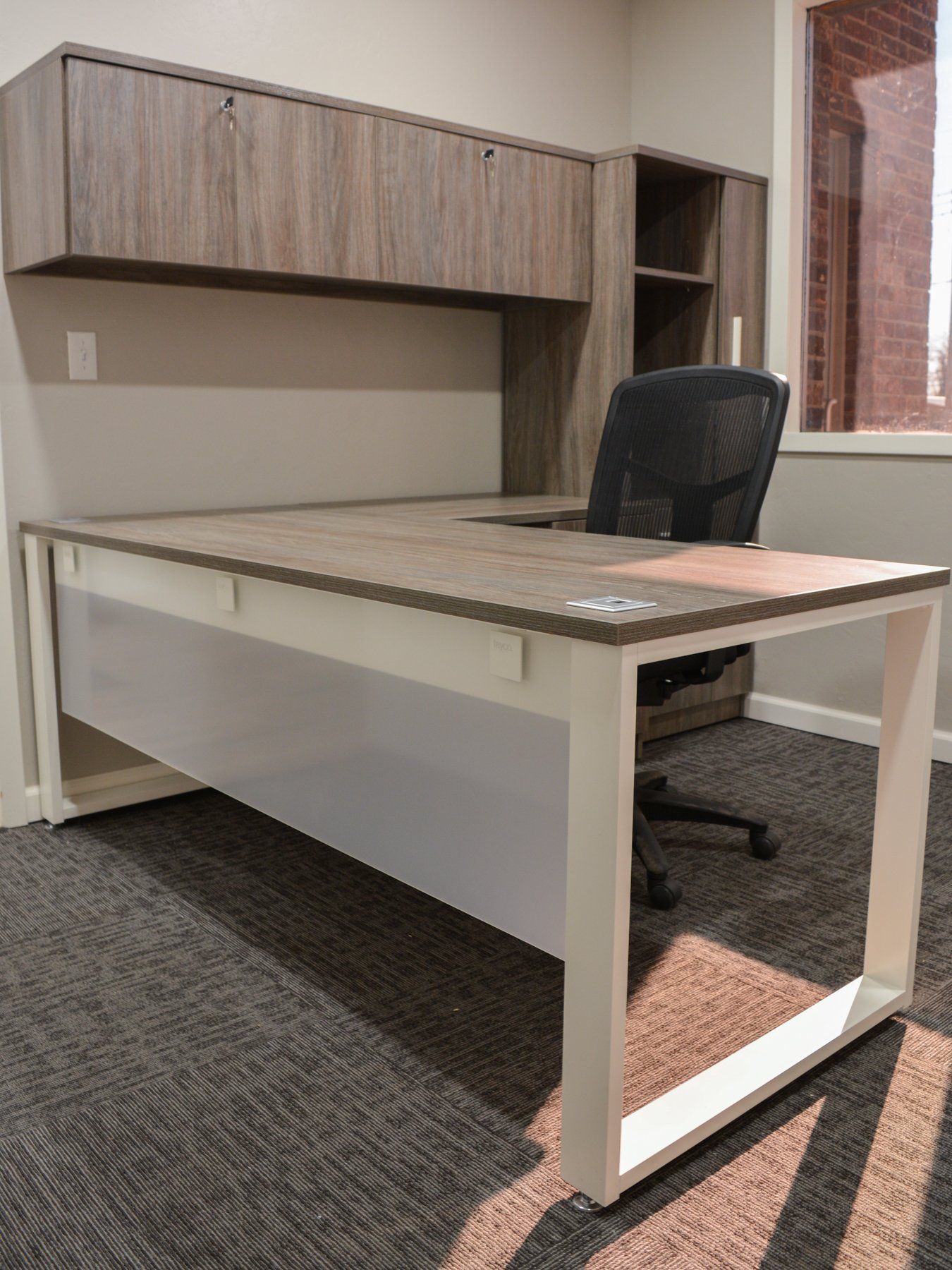 L-shape desk with white legs and black chair