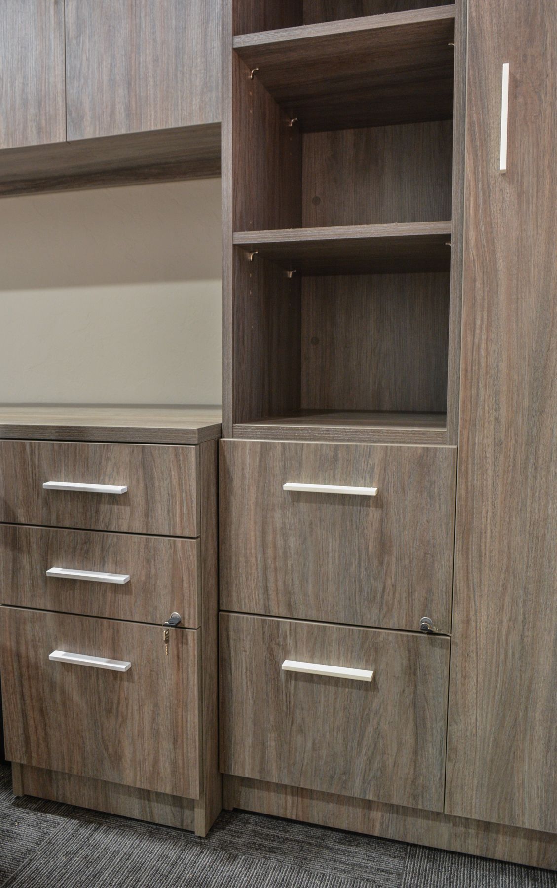A close up of a filing cabinet with drawers and shelves.