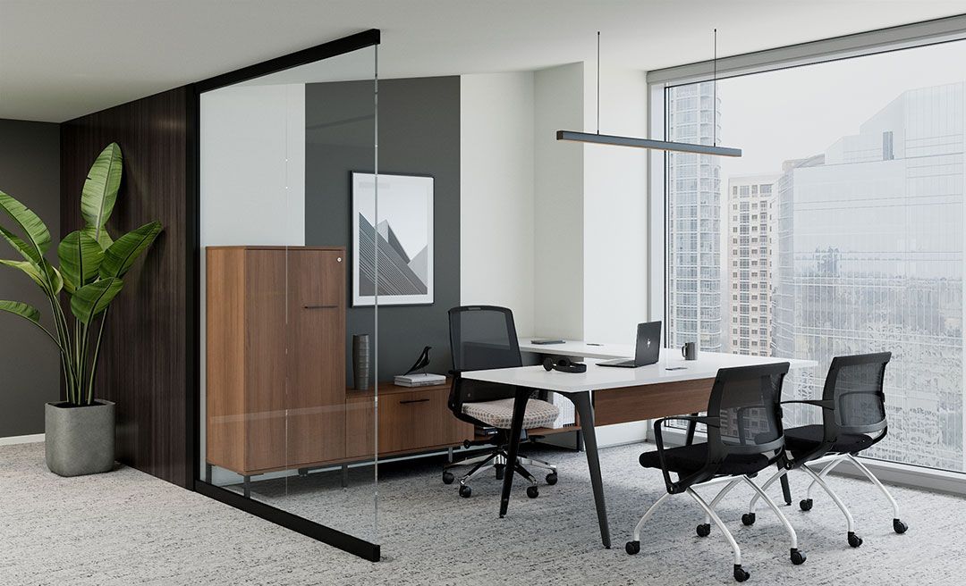 an office with two chairs and a desk with a laptop on it