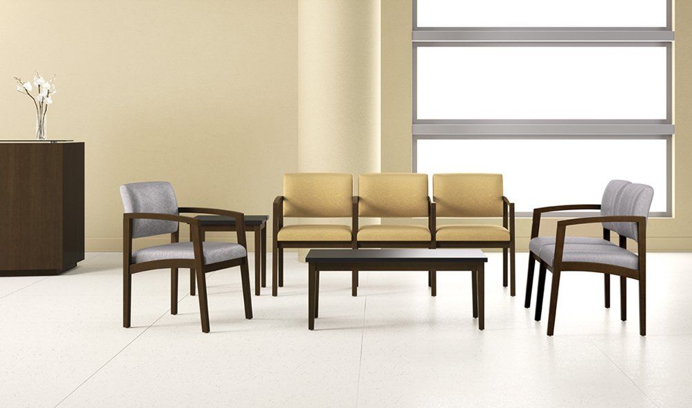 a room with chairs and a table in front of a window
