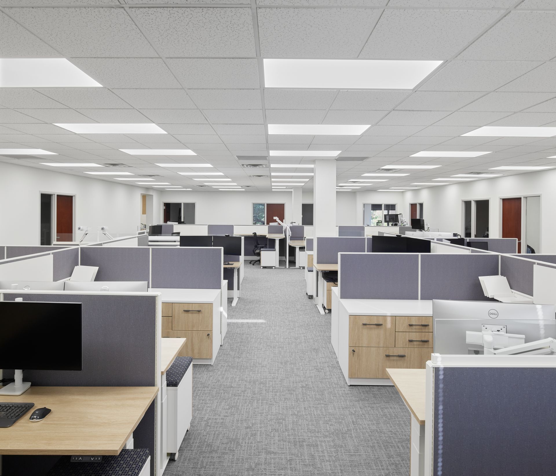 A large office with cubicles and a computer on a desk